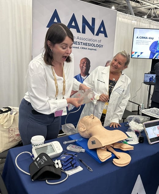 Melissa Croad, CRNA showing an attendee how to intubate